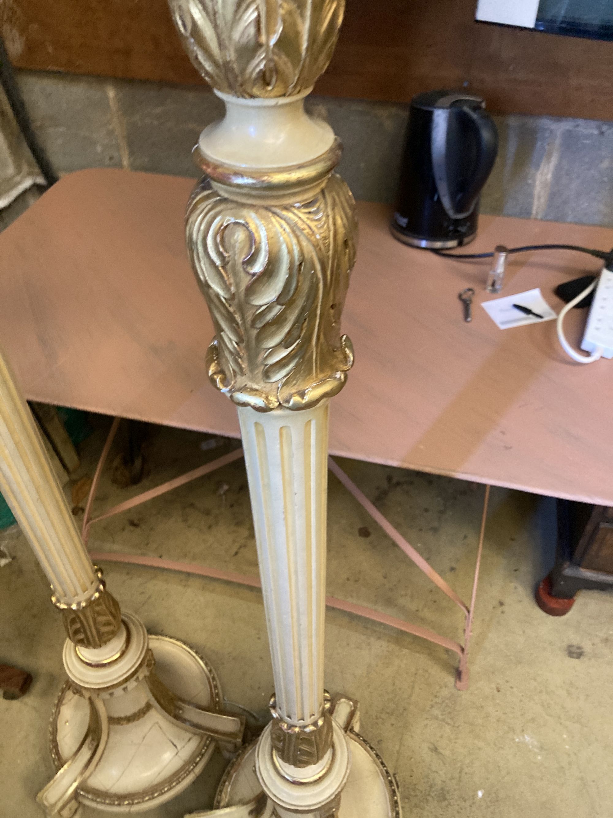 A pair of cream painted parcel gilt standard lamps, height 166cm